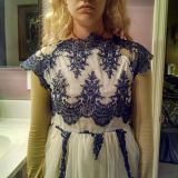 Wish I had a photo of how this dress looks in the add. Notice the crooked part near the neck, Difference in lengths of where is falls off shoulders. Front lace is a mess.