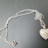 Long gray hair interwoven in the chain. You see it clearly here against the black, but I didn't notice it at first. Ewwe.